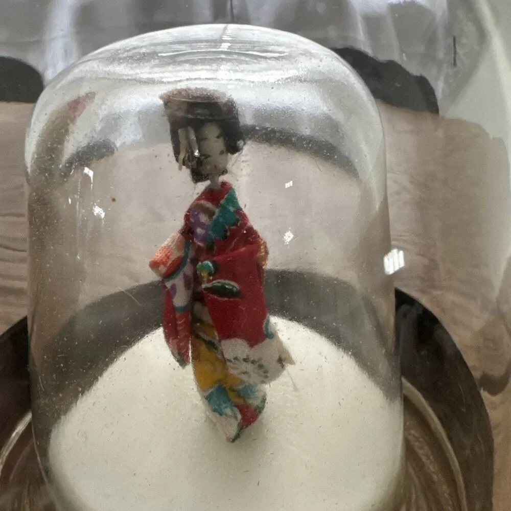 vintage Lucas Bols musical liqueur bottle featuring a  rotating geisha Inside